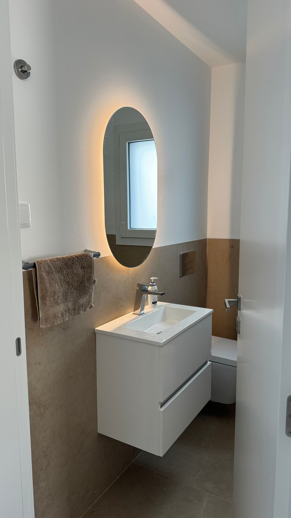 Bathroom with backlit mirror
