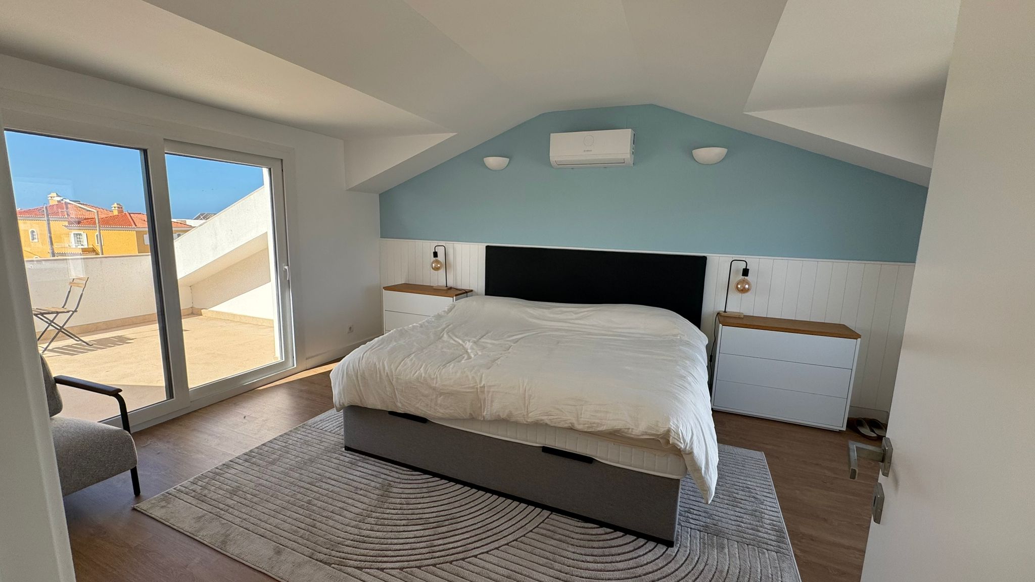 Master bedroom with blue accent wall